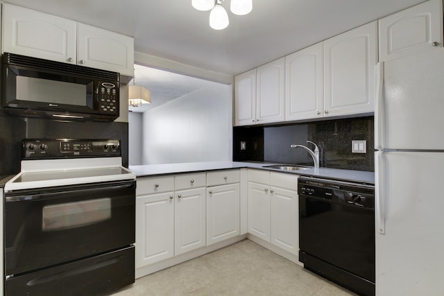 kitchen featuring black appliances, white cabinetry, decorative backsplash, and a sink