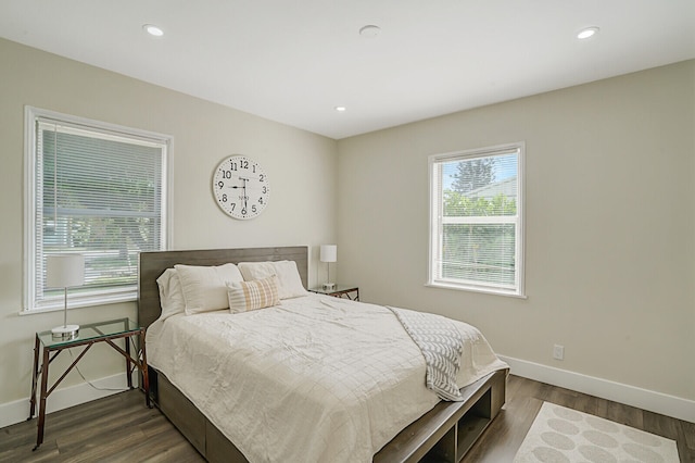 bedroom with dark hardwood / wood-style flooring