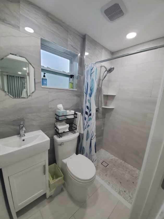 bathroom featuring tile walls, tile patterned flooring, and a shower with curtain