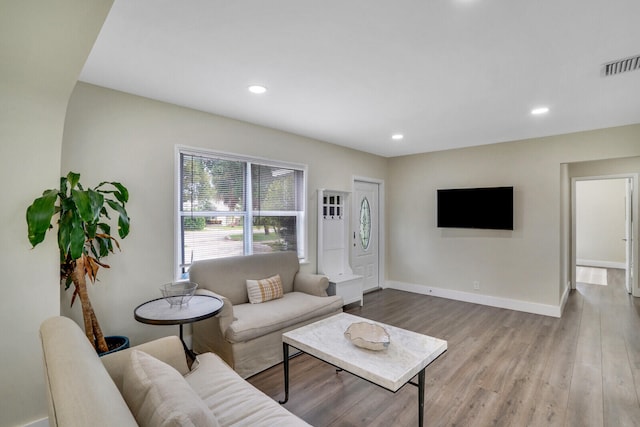 living room with light hardwood / wood-style flooring