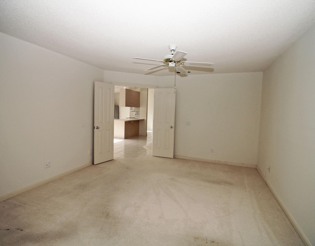 carpeted empty room with ceiling fan