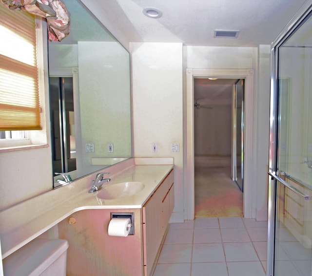 bathroom with vanity, toilet, and tile patterned floors