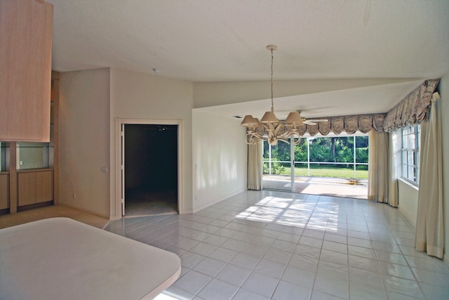 unfurnished dining area featuring vaulted ceiling, a textured ceiling, and light tile patterned floors