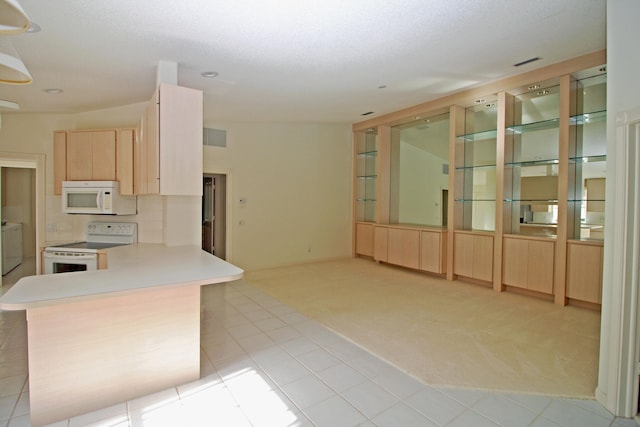 kitchen featuring backsplash, light colored carpet, separate washer and dryer, light brown cabinetry, and white appliances