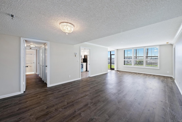 unfurnished living room with dark wood-type flooring, a textured ceiling, and ornamental molding