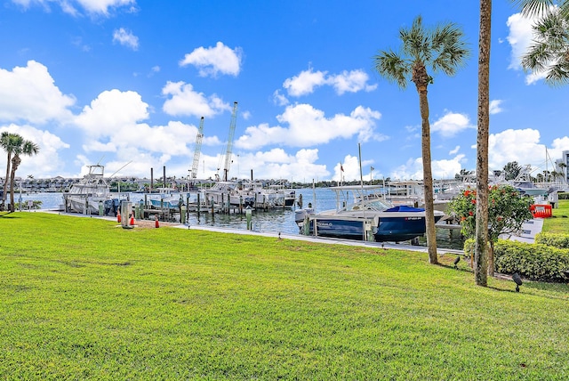 view of dock featuring a water view and a yard