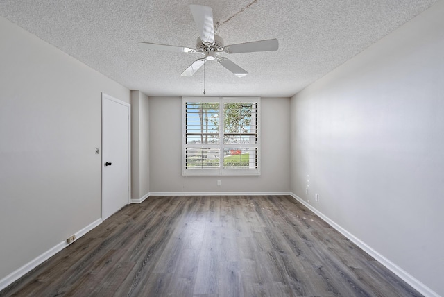 empty room featuring ceiling fan, a textured ceiling, and dark hardwood / wood-style flooring