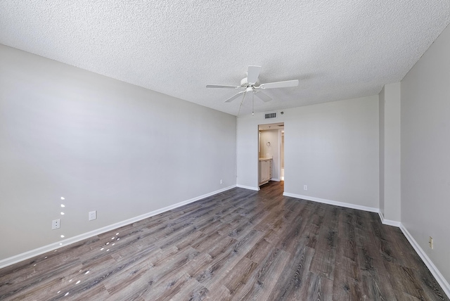 spare room with ceiling fan, a textured ceiling, and dark hardwood / wood-style flooring