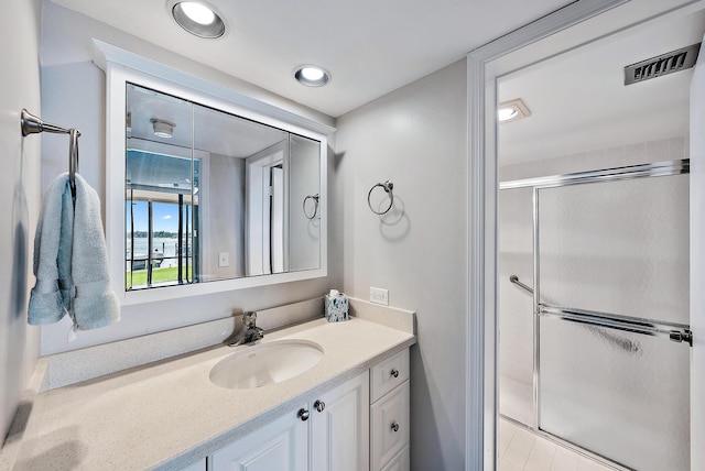 bathroom with vanity and an enclosed shower