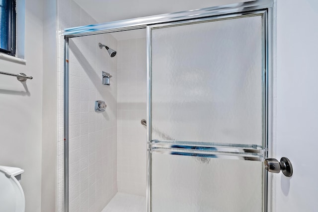 bathroom with a shower with door