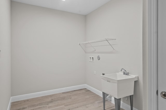 12501 SW Sunrise Lake Ter, Port Saint Lucie, FL 34987 - laundry room featuring hookup for a washing machine, light wood-style floors, and baseboards