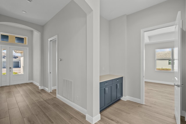 12501 SW Sunrise Lake Ter, Port Saint Lucie, FL 34987 - foyer entrance featuring light wood-style floors, arched walkways, and baseboards