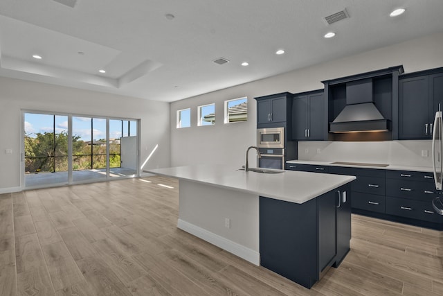 12501 SW Sunrise Lake Ter, Port Saint Lucie, FL 34987 - kitchen featuring custom exhaust hood, appliances with stainless steel finishes, a sink, light countertops, and baseboards