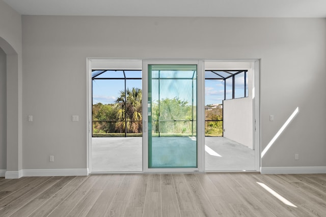12501 SW Sunrise Lake Ter, Port Saint Lucie, FL 34987 - entryway with light wood finished floors, arched walkways, and baseboards