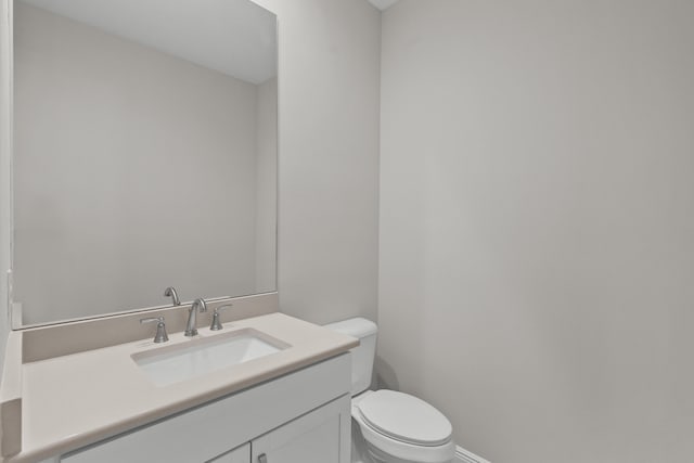 12501 SW Sunrise Lake Ter, Port Saint Lucie, FL 34987 - bathroom with toilet, vanity, and baseboards