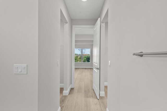 12501 SW Sunrise Lake Ter, Port Saint Lucie, FL 34987 - hallway featuring baseboards and light wood-style floors