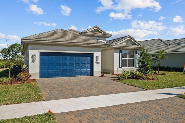 12501 SW Sunrise Lake Ter, Port Saint Lucie, FL 34987 - view of front facade featuring decorative driveway, a garage, stucco siding, a front lawn, and central air condition unit