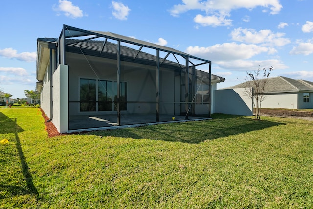 12501 SW Sunrise Lake Ter, Port Saint Lucie, FL 34987 - back of house featuring a lawn, stucco siding, a patio, and glass enclosure