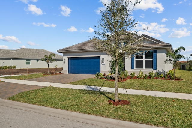 12501 SW Sunrise Lake Ter, Port Saint Lucie, FL 34987 - view of front of property featuring decorative driveway, stucco siding, a garage, and a front lawn