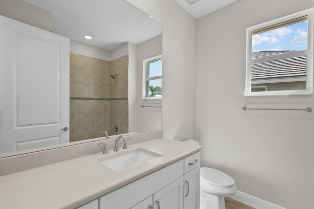 12501 SW Sunrise Lake Ter, Port Saint Lucie, FL 34987 - full bath with a tile shower, toilet, vanity, baseboards, and recessed lighting