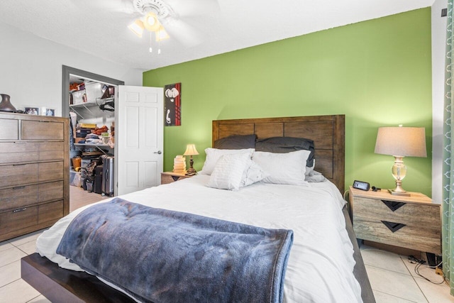 tiled bedroom with a closet and ceiling fan