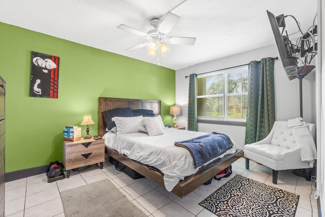 tiled bedroom featuring a textured ceiling and ceiling fan