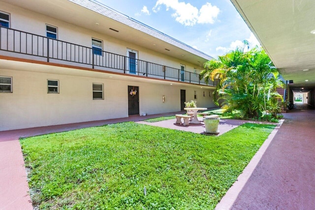 exterior space featuring a patio area and a lawn