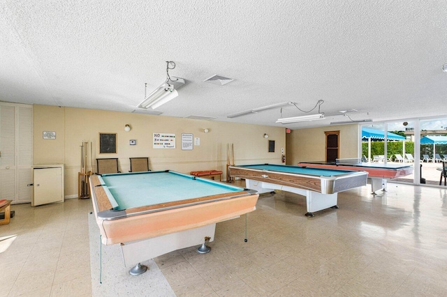 recreation room with pool table and a textured ceiling