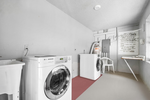 washroom with sink, a textured ceiling, electric panel, and washer and clothes dryer