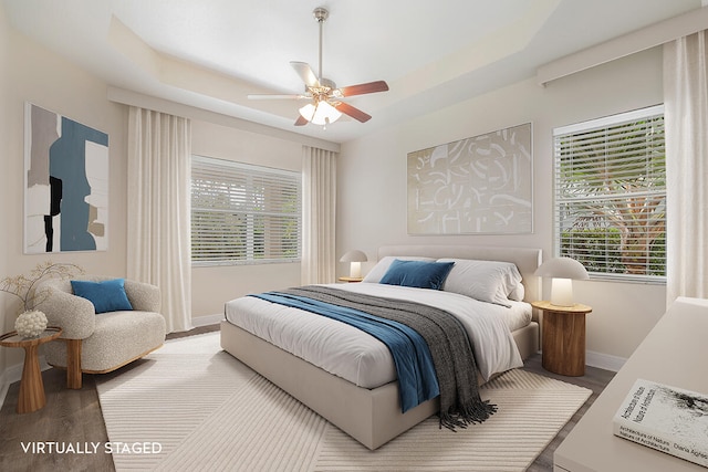 bedroom with light wood-type flooring and ceiling fan