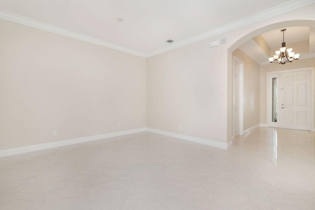 unfurnished room featuring ornamental molding and a notable chandelier