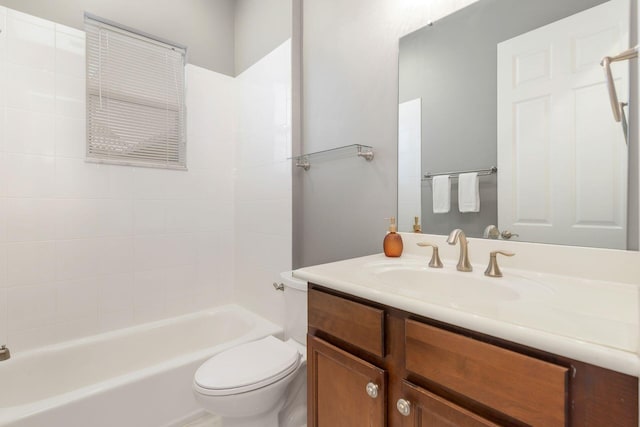 full bathroom featuring toilet, tiled shower / bath combo, and vanity