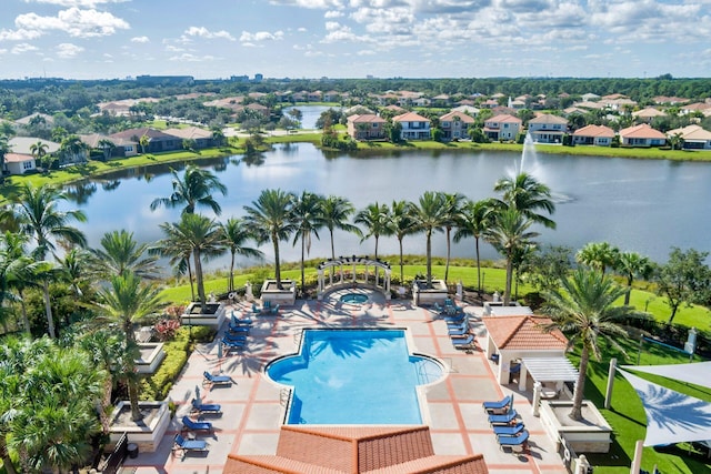 view of pool featuring a water view and a patio area