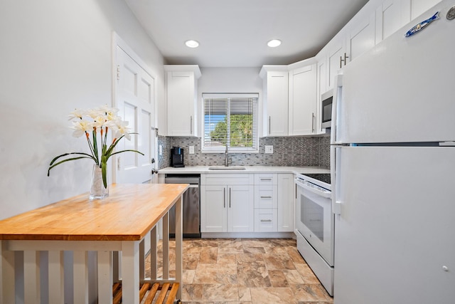 kitchen featuring butcher block countertops, sink, white cabinetry, and stainless steel appliances