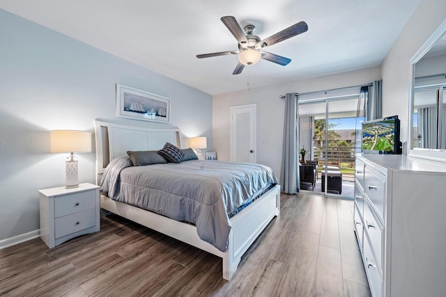 bedroom featuring a closet, hardwood / wood-style floors, access to outside, and ceiling fan