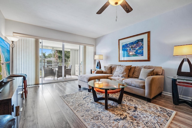 living room with hardwood / wood-style flooring and ceiling fan