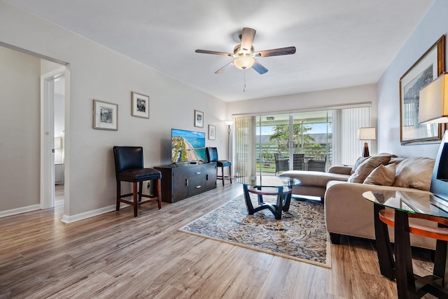 living room featuring light wood-type flooring and ceiling fan