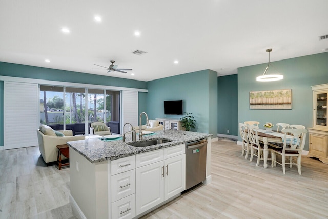 kitchen with dishwasher, hanging light fixtures, sink, white cabinetry, and light hardwood / wood-style floors