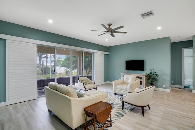 living room with ceiling fan and light wood-type flooring