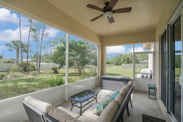 sunroom / solarium featuring ceiling fan