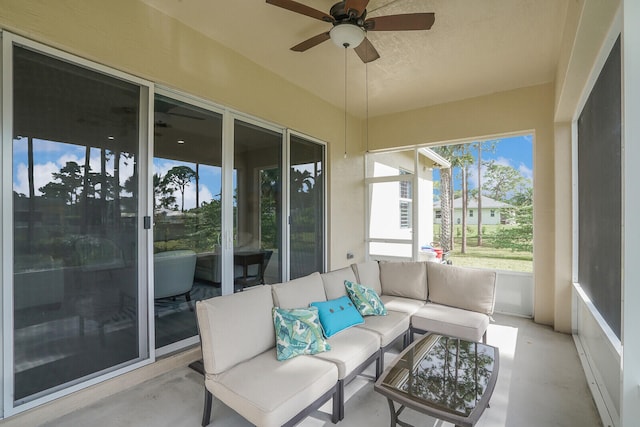 sunroom featuring ceiling fan