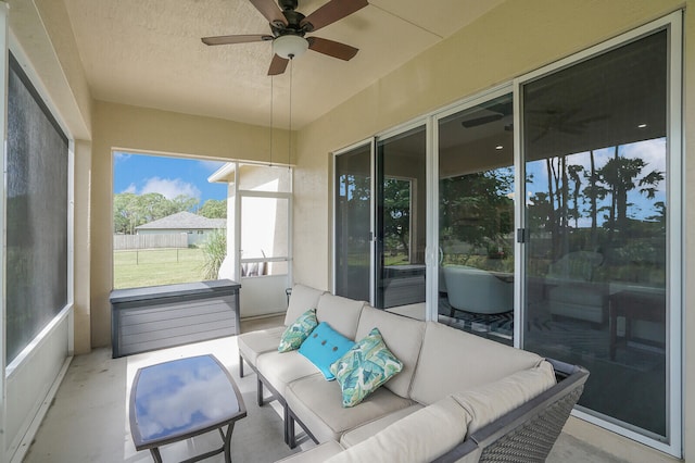 sunroom featuring ceiling fan