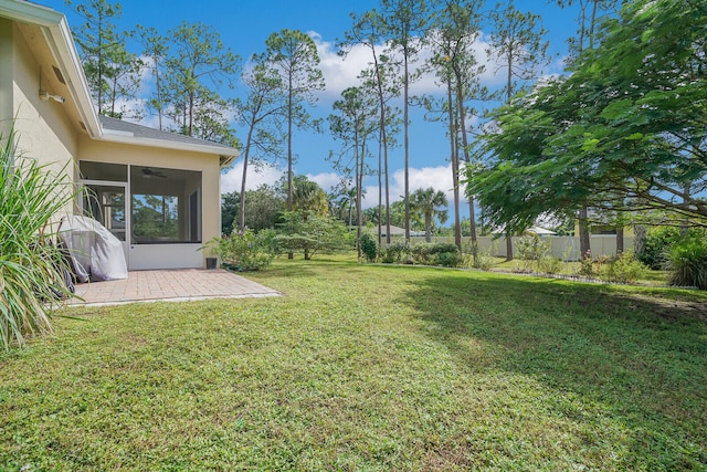 view of yard with a patio area and ceiling fan