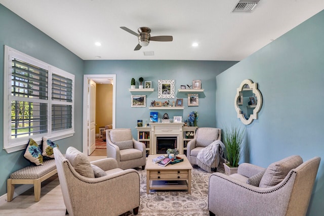 living room featuring light wood-type flooring and ceiling fan