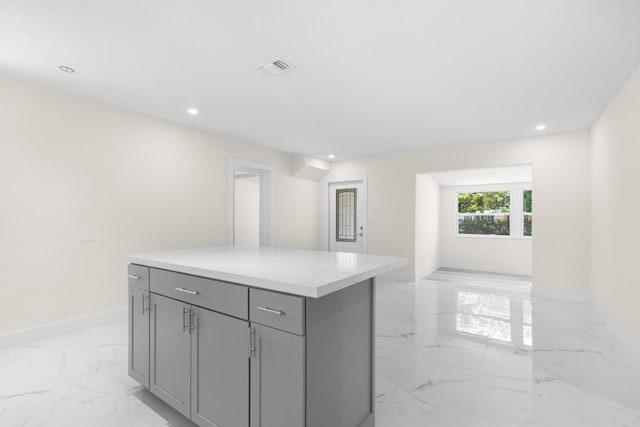 kitchen featuring gray cabinets and a center island