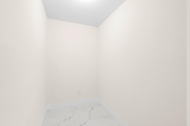 unfurnished room featuring a textured ceiling