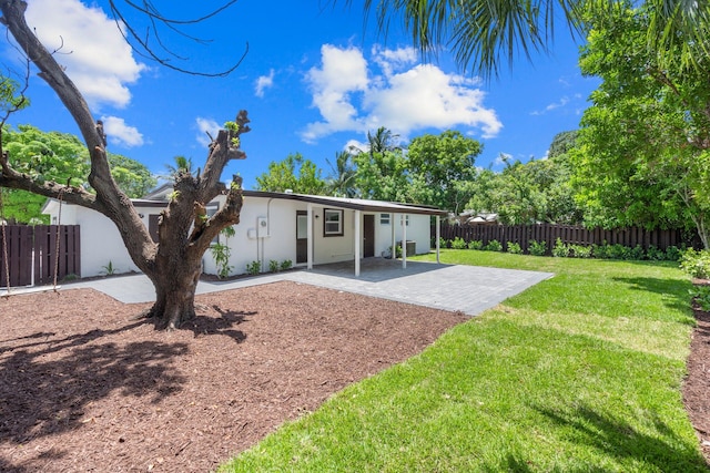 exterior space with a front yard and a patio