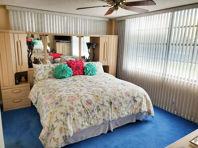 bedroom featuring carpet, a textured ceiling, and ceiling fan