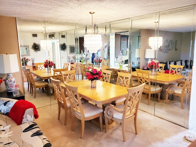 dining area featuring a textured ceiling and a chandelier