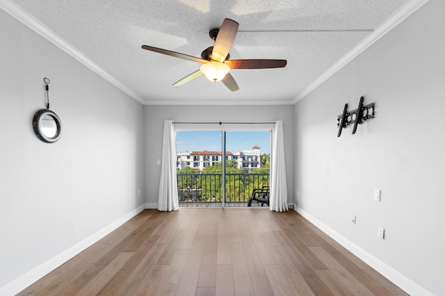 spare room with a textured ceiling, ceiling fan, light hardwood / wood-style floors, and crown molding